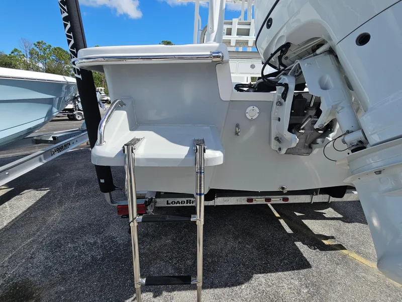 Slide: The Image of 2025 Savannah SS21 boat with swim platform and ladder, parked on a trailer. - 24