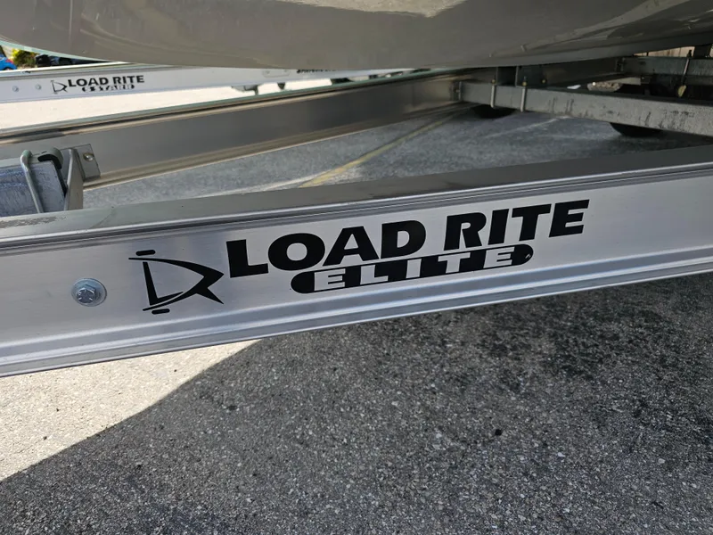Slide: The Image of Load Rite Elite trailer frame, Savannah SS21 2025 model, on asphalt surface. - 6