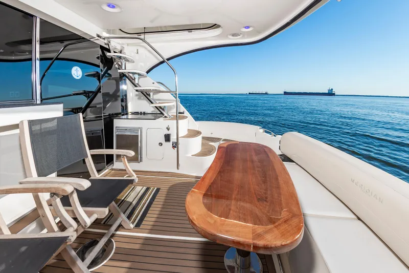 Slide: The Image of Luxurious 2011 Meridian 541 Sedan yacht deck with seating, table, and ocean view. - 15