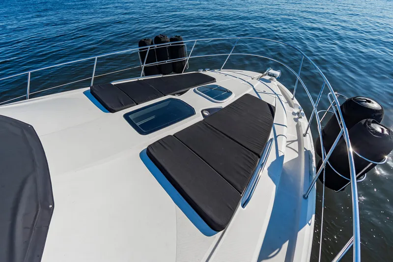 Slide: The Image of 2011 Meridian 541 Sedan yacht deck with sun loungers on calm water. - 19