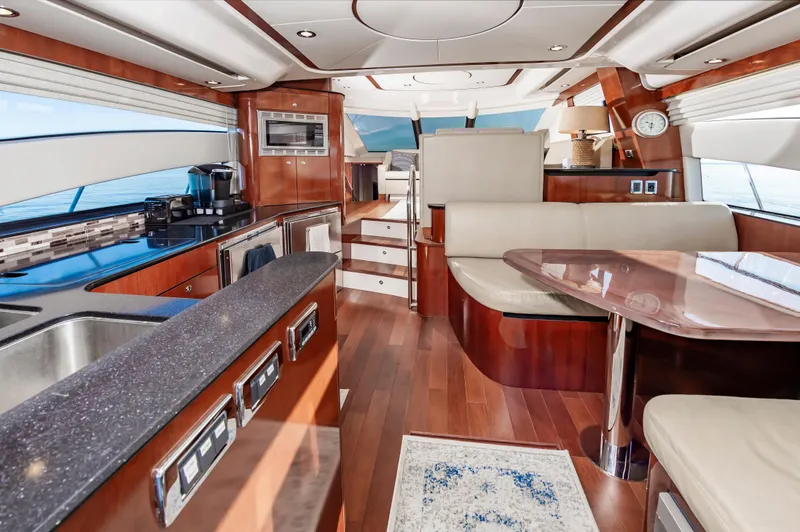 Slide: The Image of Luxurious interior of a 2011 Meridian 541 Sedan yacht with modern kitchen and seating area. - 20