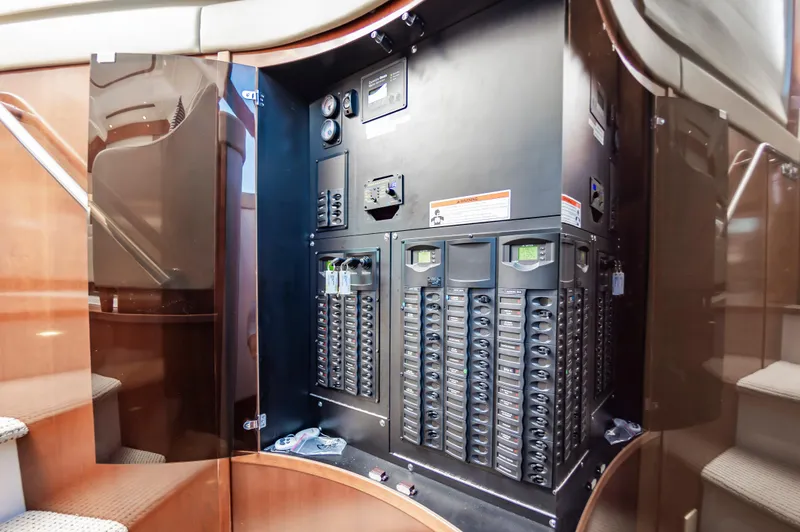 Slide: The Image of Electrical panel inside 2011 Meridian 541 Sedan yacht, featuring circuit breakers and control gauges. - 29