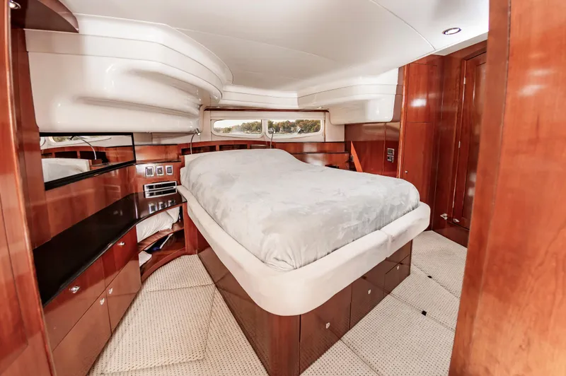 Slide: The Image of Luxurious cabin interior of 2011 Meridian 541 Sedan yacht with wood finishes and plush bedding. - 31