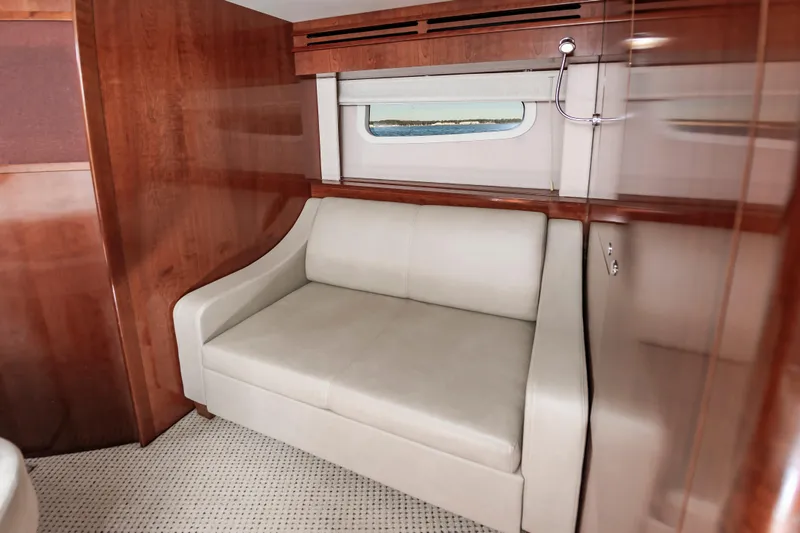 Slide: The Image of Interior of 2011 Meridian 541 Sedan yacht with cream sofa and wooden paneling. - 32