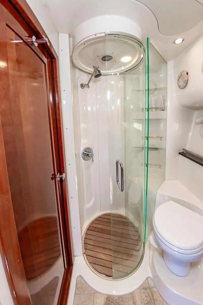Slide: The Image of Luxurious bathroom in 2011 Meridian 541 Sedan yacht with glass shower and wooden accents. - 43