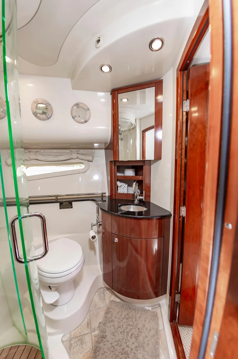 Slide: The Image of Luxurious bathroom in 2011 Meridian 541 Sedan yacht with modern fixtures and wood accents. - 44