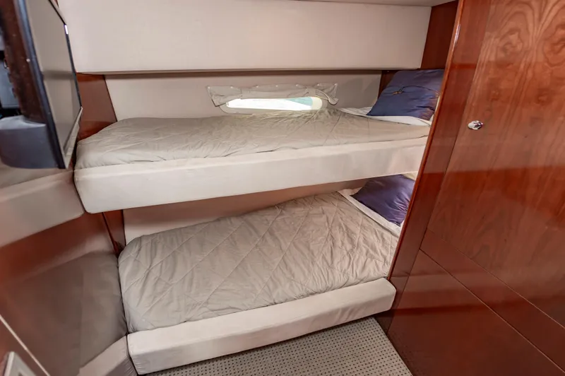 Slide: The Image of Bunk beds in 2011 Meridian 541 Sedan yacht cabin with wooden interior. - 45