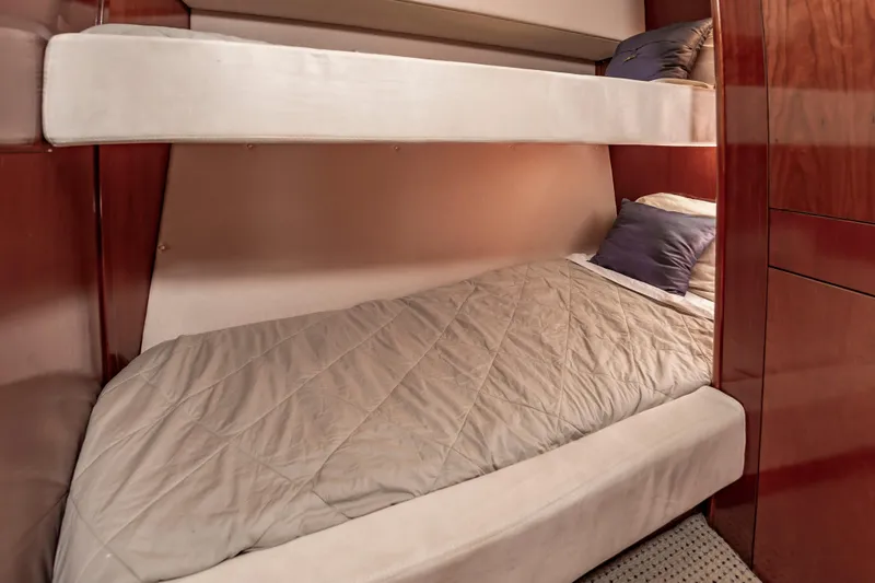 Slide: The Image of Bunk beds in 2011 Meridian 541 Sedan yacht cabin with wooden interior. - 46