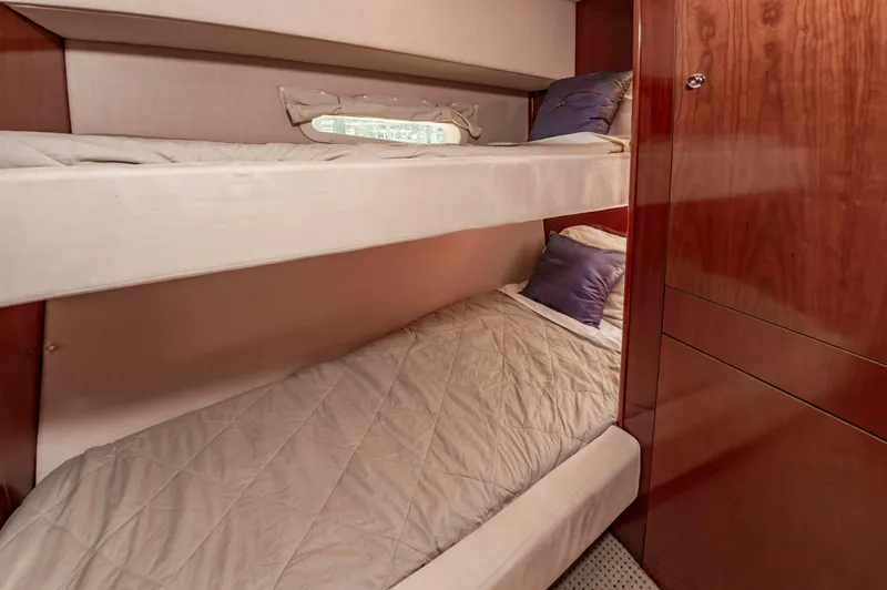 Slide: The Image of Bunk beds in 2011 Meridian 541 Sedan yacht cabin with wooden interior. - 47