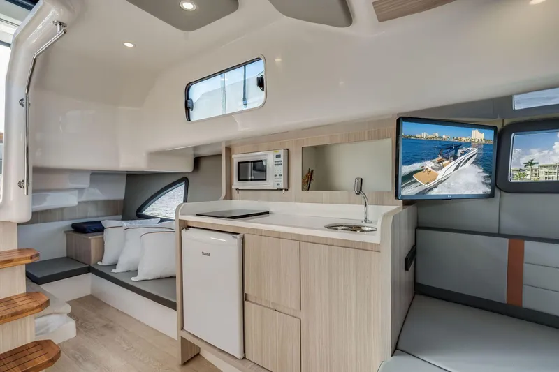 Slide: The Image of Interior of 2025 Hanover 377 Outboard boat with modern kitchen and seating area. - 15