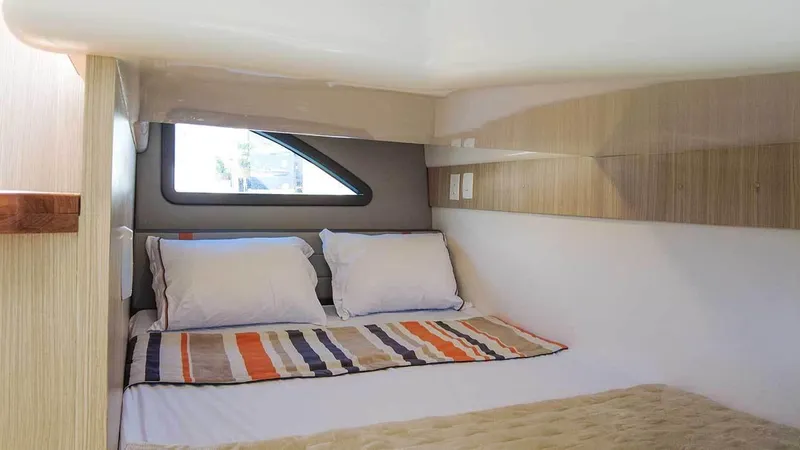 Slide: The Image of Cozy cabin interior of 2025 Hanover 377 Outboard with modern bedding and window. - 17