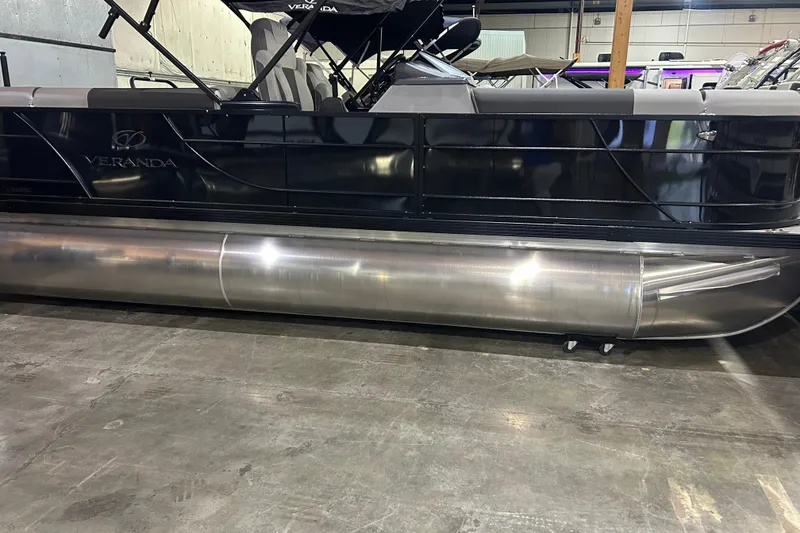 Slide: The Image of 2025 Veranda Relax VR22RC pontoon boat in showroom, side view. - 2