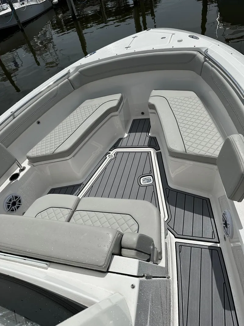 Slide: The Image of 2023 Pursuit S 288 Sport boat interior with cushioned seating and sleek design. - 22