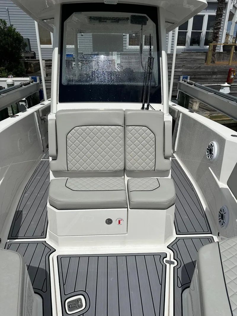 Slide: The Image of 2023 Pursuit S 288 Sport boat interior with cushioned seating and sleek design. - 23