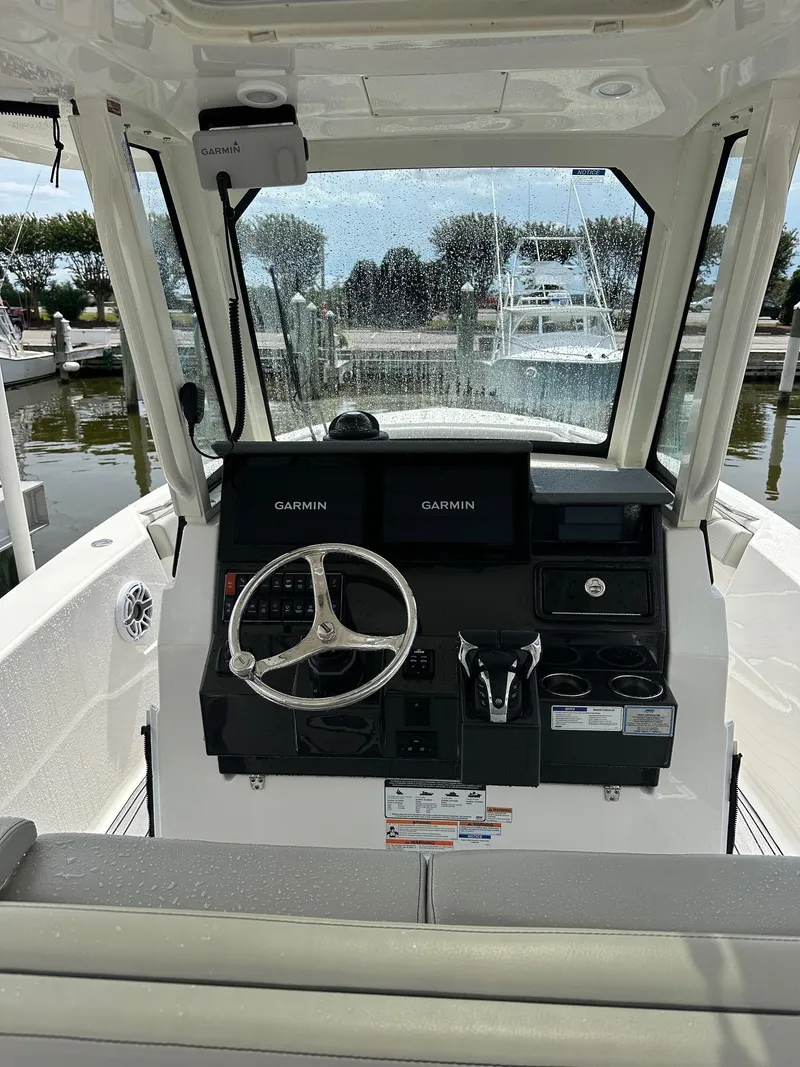 Slide: The Image of 2023 Pursuit S 288 Sport boat cockpit with Garmin navigation system. - 24