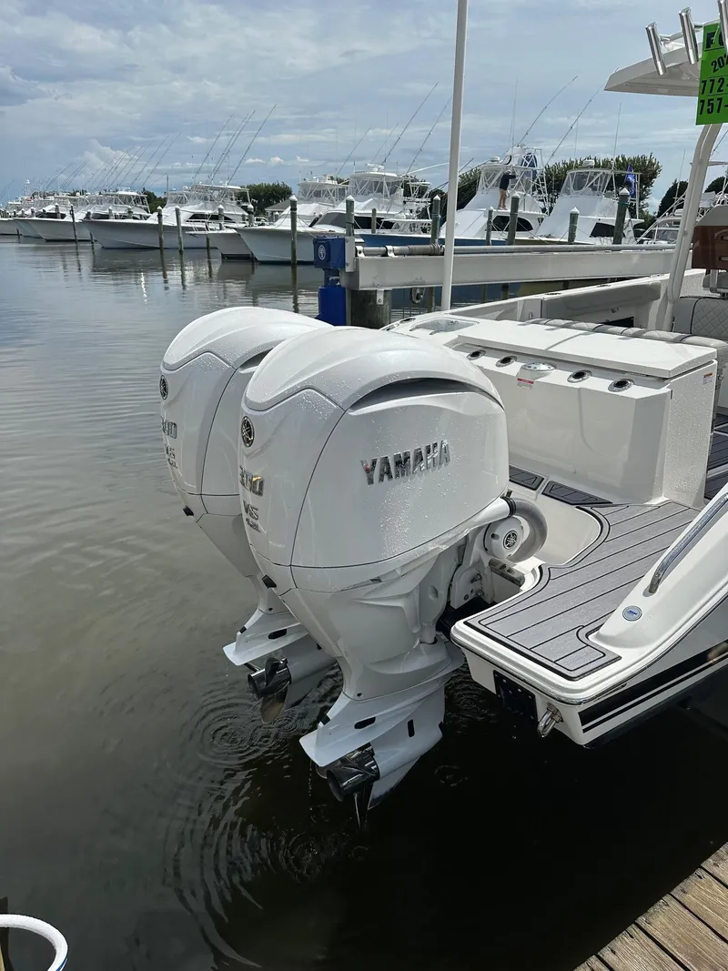 Slide: The Image of 2023 Pursuit S 288 Sport boat with twin Yamaha outboard engines docked at marina. - 28