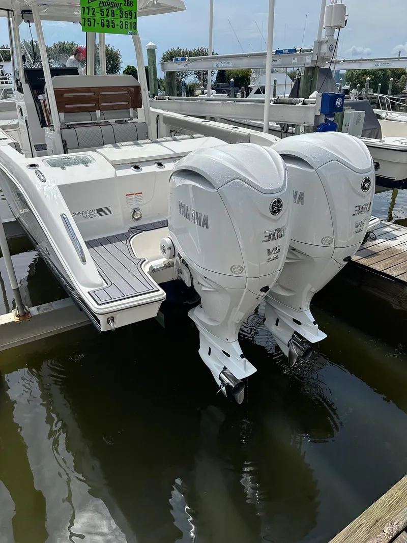 Slide: The Image of 2023 Pursuit S 288 Sport boat with twin Yamaha outboard engines at a marina. - 29
