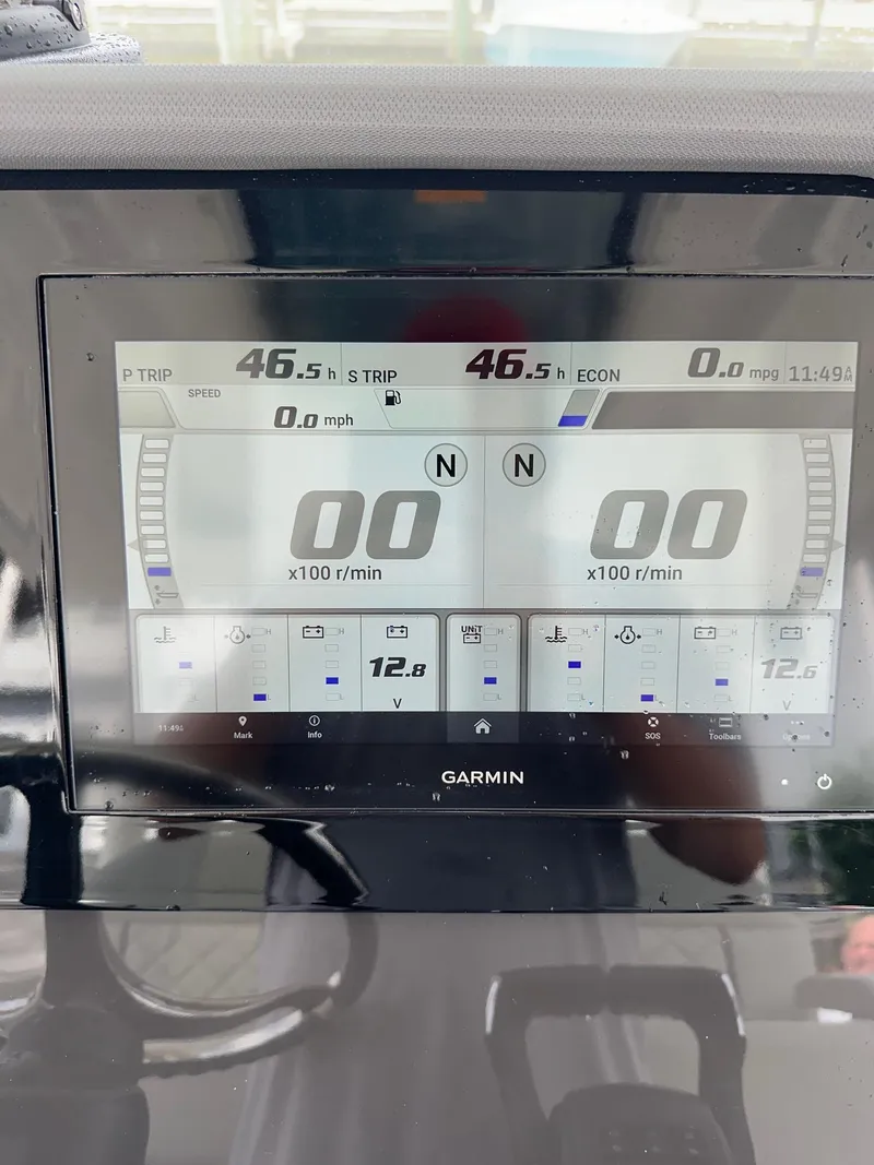Slide: The Image of Garmin display on 2023 Pursuit S 288 Sport boat dashboard showing speed and engine data. - 31
