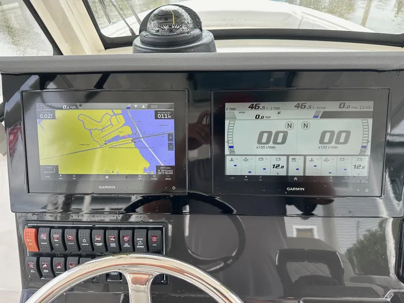 Slide: The Image of Dashboard of 2023 Pursuit S 288 Sport boat with Garmin navigation displays. - 32