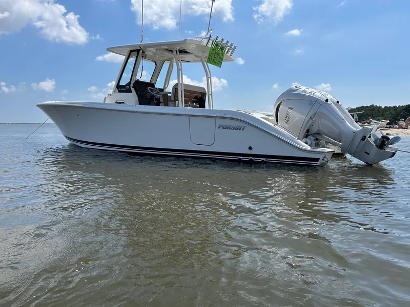 Slide: The Image of 2023 Pursuit S 288 Sport boat on calm water under a clear blue sky. - 35