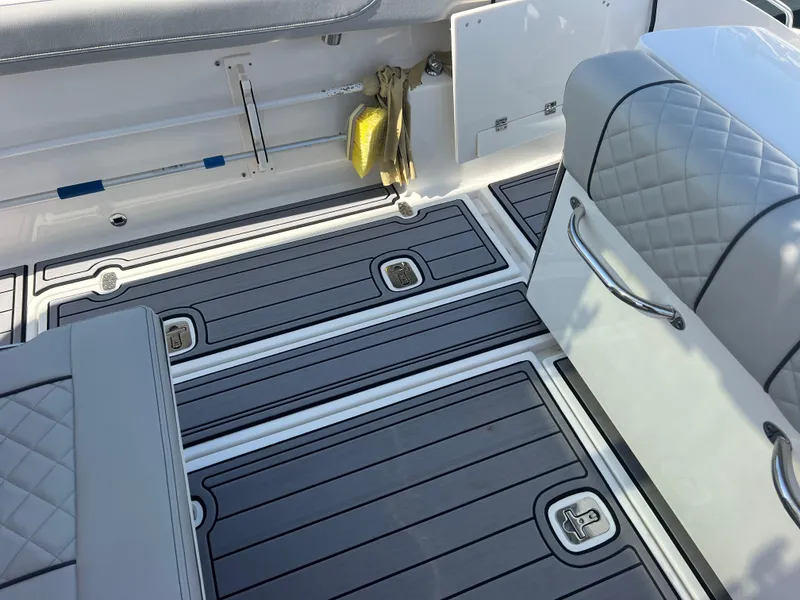 Slide: The Image of 2023 Pursuit S 288 Sport boat interior with gray cushioned seating and sleek flooring. - 41