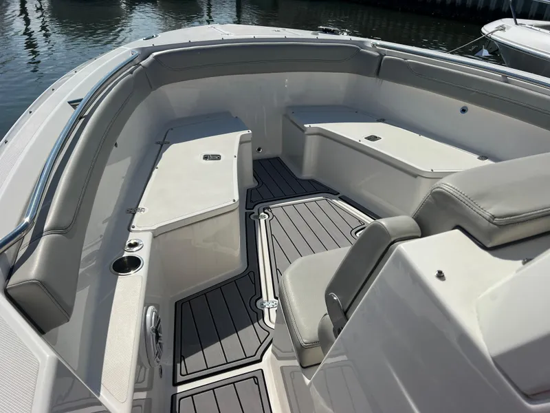Slide: The Image of 2023 Pursuit S 288 Sport boat interior with cushioned seating and sleek design. - 47