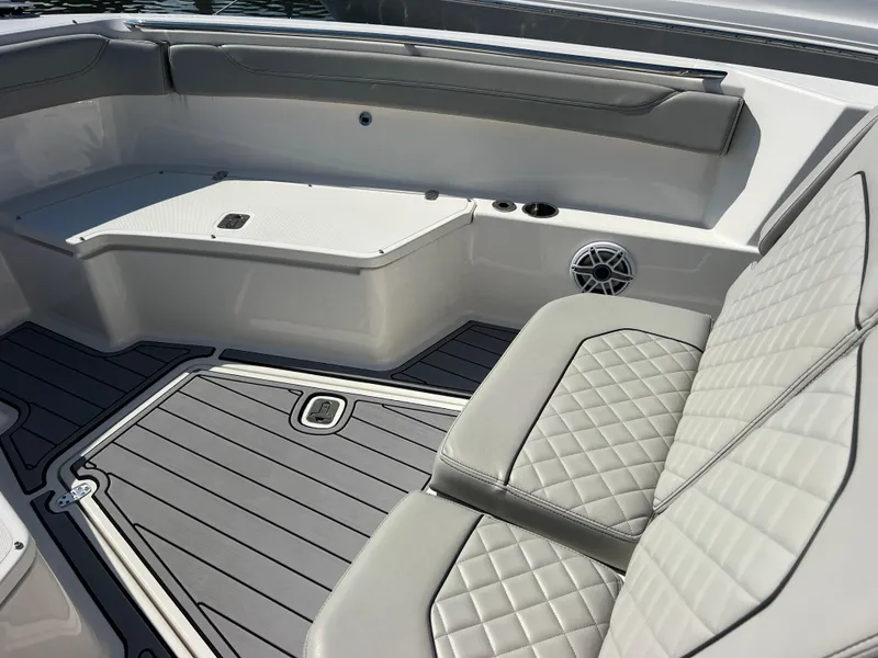 Slide: The Image of 2023 Pursuit S 288 Sport boat interior with gray seating and flooring. - 48