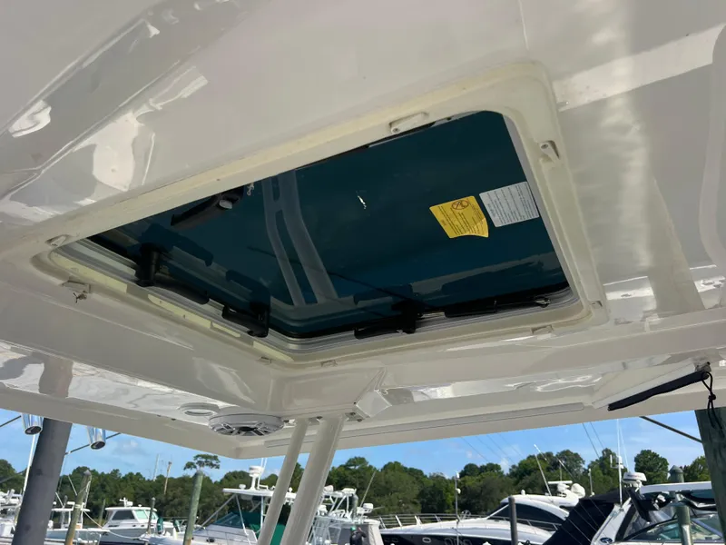 Slide: The Image of 2023 Pursuit S 288 Sport boat hatch with marina background. - 49
