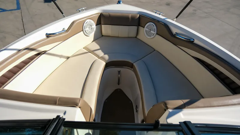 Slide: The Image of 2013 Sea Ray 210 SLX boat interior with beige seating and speakers. - 14