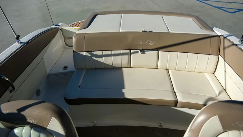 Slide: The Image of 2013 Sea Ray 210 SLX boat interior with beige seating. - 16