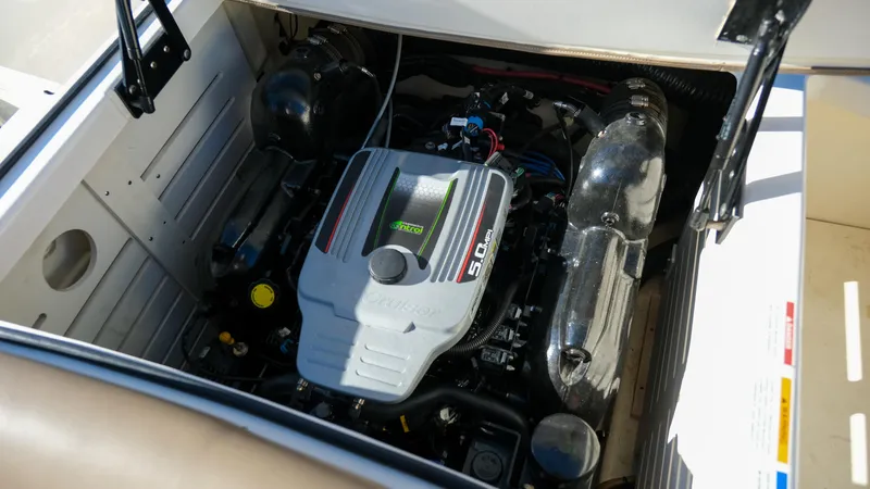 Slide: The Image of Engine compartment of a 2013 Sea Ray 210 SLX boat, showcasing the 5.0L engine. - 17