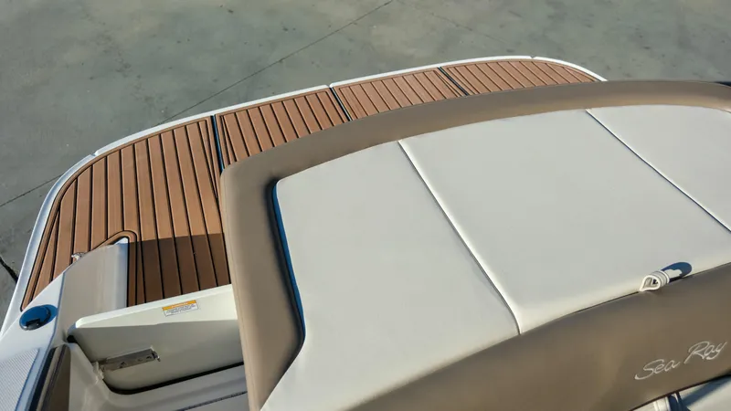 Slide: The Image of 2013 Sea Ray 210 SLX boat with teak deck and cushioned seating. - 19