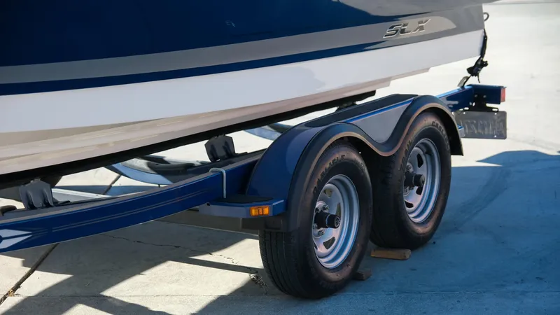 Slide: The Image of 2013 Sea Ray 210 SLX boat on a dual-axle trailer, side view. - 3