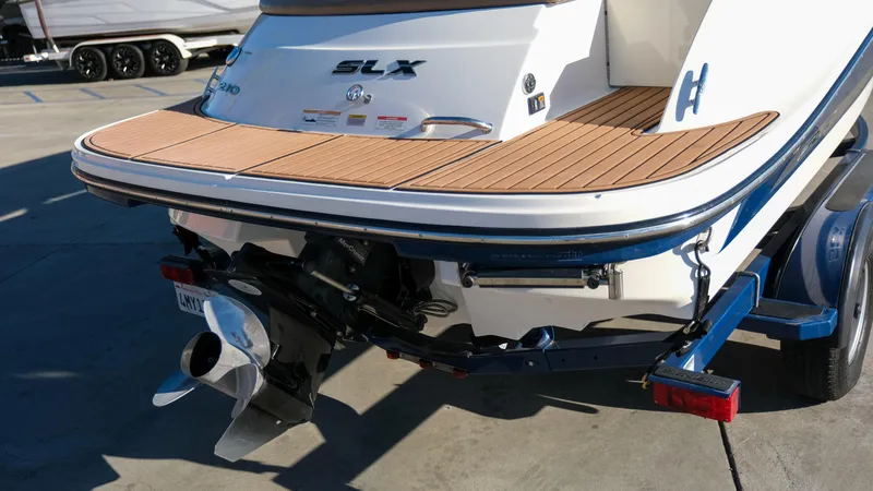 Slide: The Image of 2013 Sea Ray 210 SLX boat rear view with teak swim platform. - 5
