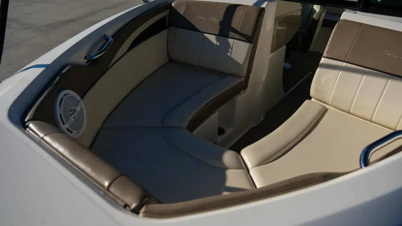 Slide: The Image of Interior seating of 2013 Sea Ray 210 SLX boat, featuring beige and brown upholstery. - 9