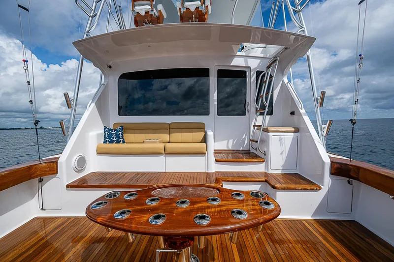 Slide: The Image of 2003 Viking Convertible yacht interior with wooden deck and seating area. - 10