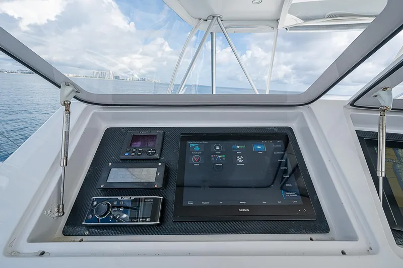 Slide: The Image of 2003 Viking Convertible yacht dashboard with navigation and control systems. - 15