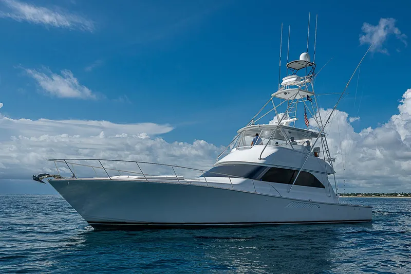 Slide: The Image of 2003 Viking Convertible yacht on open sea under clear blue sky. - 2