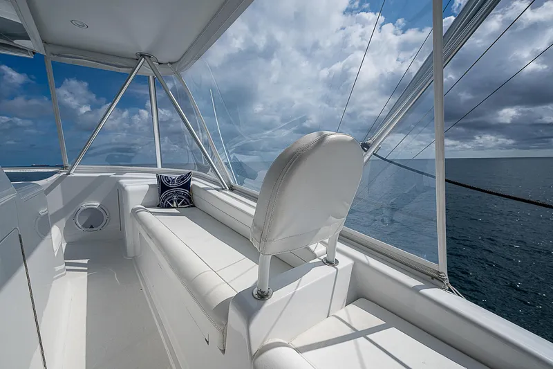 Slide: The Image of Interior of 2003 Viking Convertible yacht with ocean view and white seating. - 20