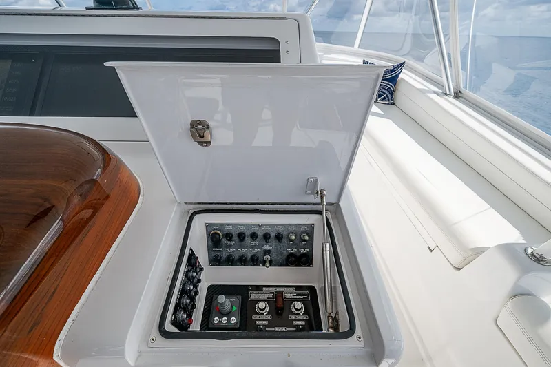 Slide: The Image of Control panel on a 2003 Viking Convertible yacht, featuring various switches and dials. - 21
