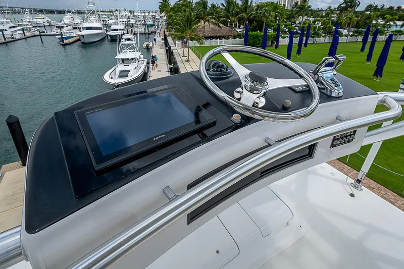Slide: The Image of Control panel of a 2003 Viking Convertible yacht at a marina. - 25