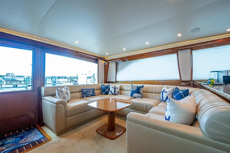 Slide: The Image of Luxurious interior of a 2003 Viking Convertible yacht with plush seating and decorative pillows. - 27