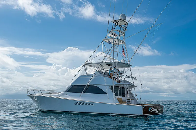 Slide: The Image of 2003 Viking Convertible yacht on open sea under clear blue sky. - 3