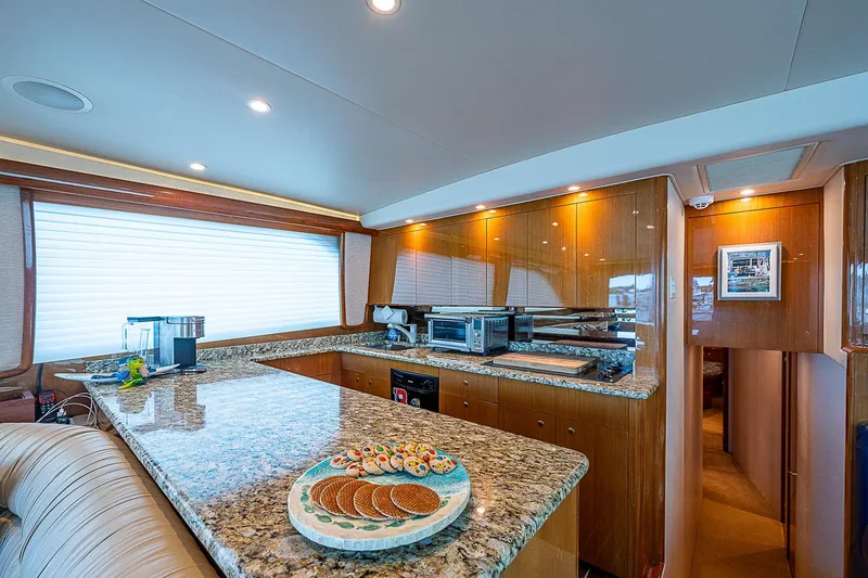 Slide: The Image of Luxurious kitchen interior of a 2003 Viking Convertible yacht with granite countertops. - 31