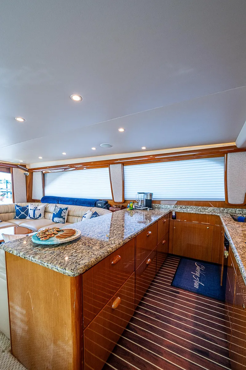 Slide: The Image of Luxurious interior of a 2003 Viking Convertible yacht with granite countertops and plush seating. - 33