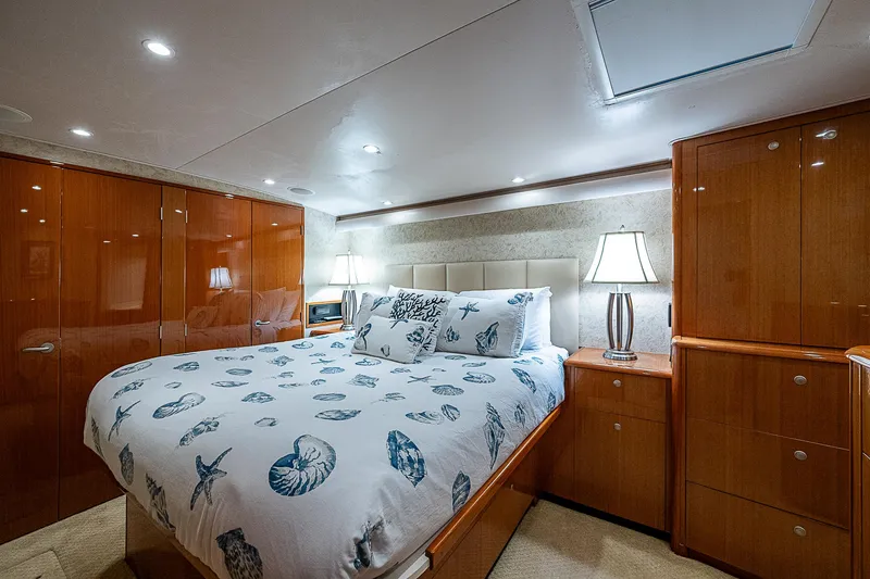 Slide: The Image of Luxurious bedroom interior on a 2003 Viking Convertible yacht, featuring elegant wood cabinetry. - 35