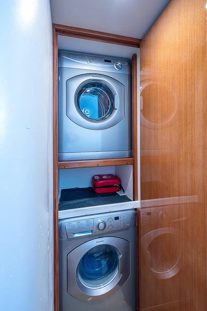 Slide: The Image of Stacked washer and dryer in a 2003 Viking Convertible yacht laundry area. - 38