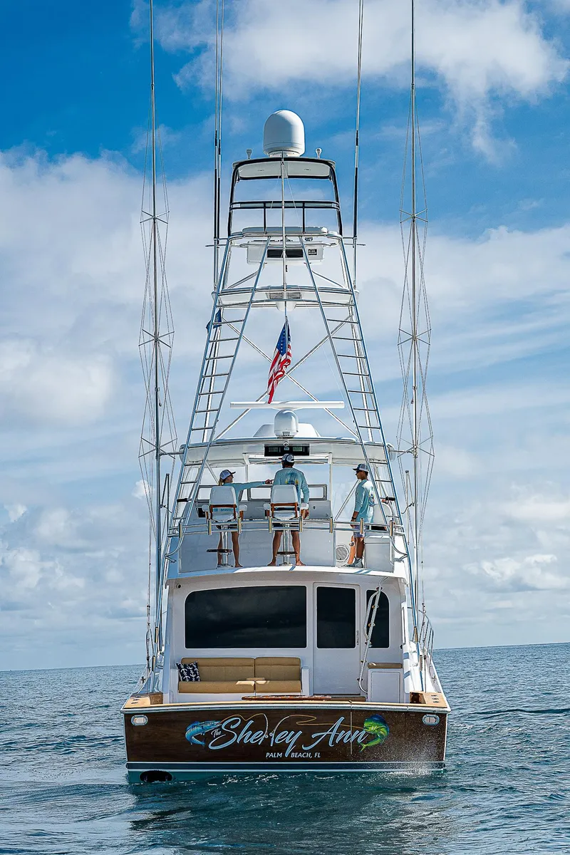 Slide: The Image of 2003 Viking Convertible yacht on open sea, featuring tower and American flag. - 5