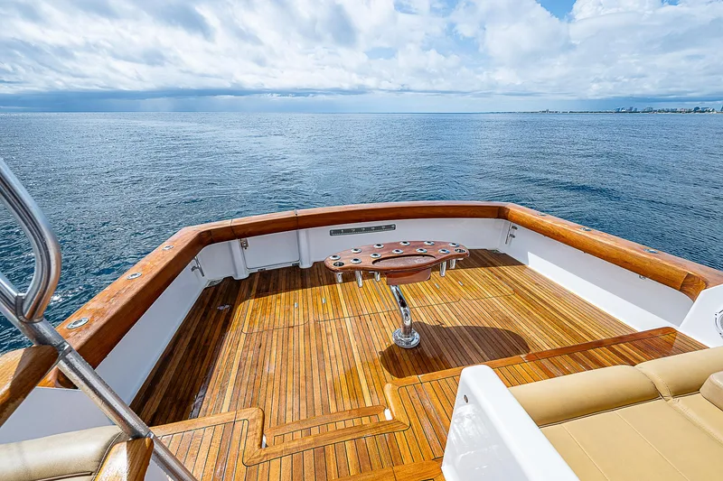 Slide: The Image of 2003 Viking Convertible yacht deck with wooden flooring, overlooking the ocean. - 7
