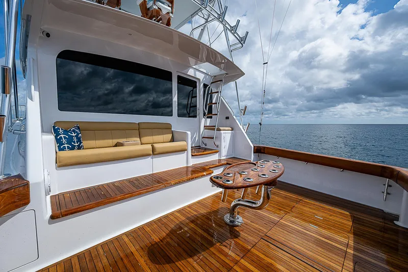 Slide: The Image of 2003 Viking Convertible yacht deck with seating, ocean view, and wooden flooring. - 9
